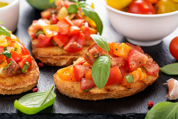 Italian bruschetta with chopped tomatoes and basil   on grilled crusty bread.