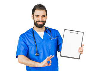 Doctor in blue robe with stethoscope pointing to clipboard isolated on white background