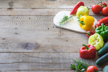 Selection of colorful vegetable on wooden table. Cooking fresh food background.