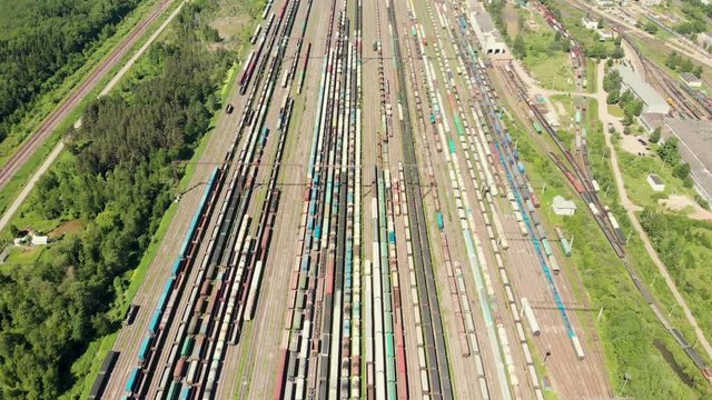 Branches of the railway at the marshalling yard, a lot of freight wagons from the height. Wagons with coal moving on rails