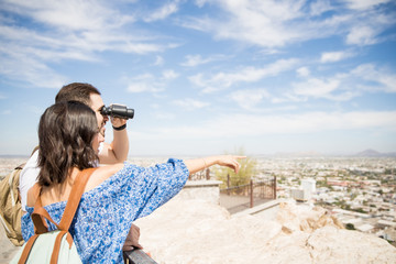 Fototapeta na wymiar Happy young couple looking with binoculars