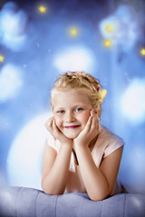 Portrait of cute blonde teen girl on background of fabulous night with clouds