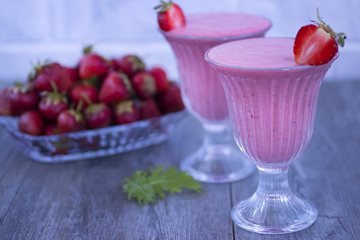 Strawberry smoothies on gray background.