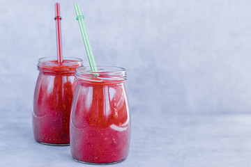 Strawberry smoothies on gray background.
