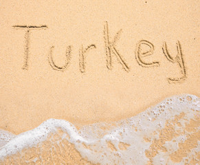The word Turkey written in the sand on beach