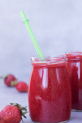 Strawberry smoothies on gray background.