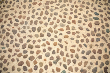 Сobblestone as paving stone, Conglomerate of assorted irregular pebbles in cement, floor or background