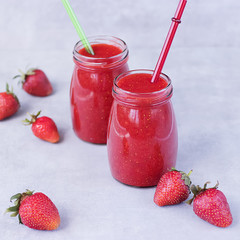 Strawberry smoothies on gray background.