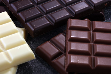 chocolate in different color. milk, dark and white chocolate bars