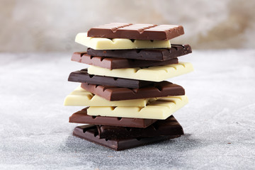 chocolate in different color. milk, dark and white chocolate bars