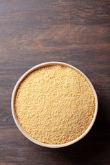 Top view of Raw couscous in bowl