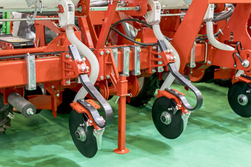 Plow modern tech red tractor close up on an agricultural field. Mechanism. Precision inline seeder....