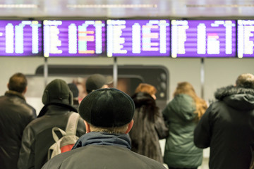 People at the airport are waiting for the arrival of the flight. Selected focus
