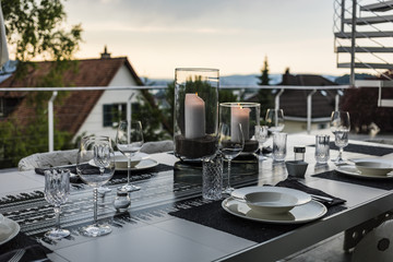 Table setting for romantic dinner on the terrace of luxurious house