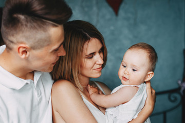 Young parents and little daughter family portrait