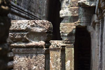 Ancient ruin of Ta Prohm temple, Angkor Wat complex, Siem Reap, Cambodia. Stone carving on pillar...