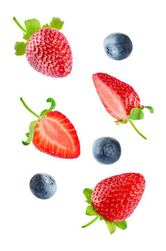 Fresh flying strawberries and blueberries isolated