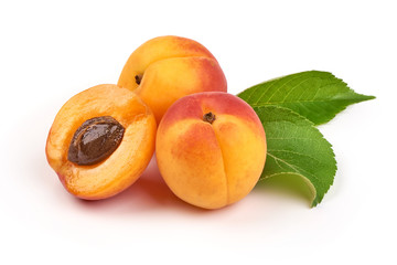 Fresh whole apricot fruit with leaf and half with core, isolated on white background.