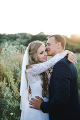 Wedding in the mountains. The bride and groom at sunset. 