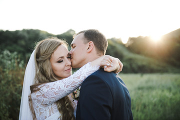 Wedding in the mountains. The bride and groom at sunset. 