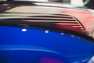Fototapeta na wymiar Close up shot headlight in luxury blue car background. Modern and expensive sport car concept