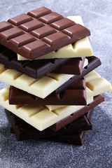 chocolate in different color. milk, dark and white chocolate bars