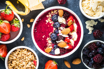 Smoothie bowl from fresh berries, nuts and granola.