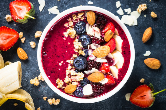 Smoothie bowl from fresh berries, nuts and granola.