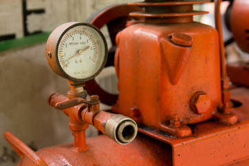  close up manometer on mechanic inflating tire. measuring air pressure.