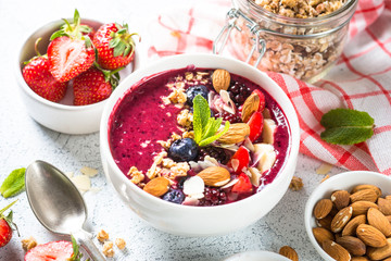 Smoothie bowl from fresh berries, nuts and granola.