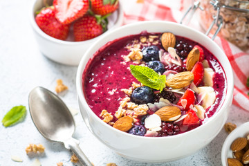 Smoothie bowl from fresh berries, nuts and granola.
