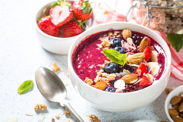 Smoothie bowl from fresh berries, nuts and granola.