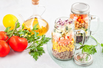 Fresh homemade salad in jars with quinoa, chickpeas  and organic vegetables. Healthy food, vegeterian, detox concept