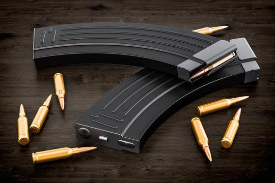Magazine from assault rifle and bullets on the wooden table, 3D rendering