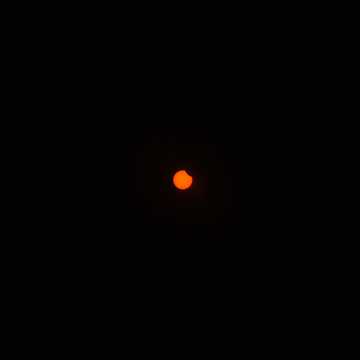 Distant sun during a partial solar eclipse.