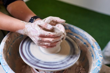 Pottery wheel. Occupation of art therapy. Making a pot of clay. Female hands