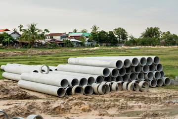 stacked of concrete, cement pipes. concrete pipes for irrigation at construction site