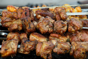 Appetizing meat grilled on skewers. Cooking shashlik. Grilling pork on coal