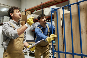 Worker Discussing With Colleague In Sofa Workshop