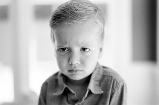 Portrait of a young boy making a funny expression