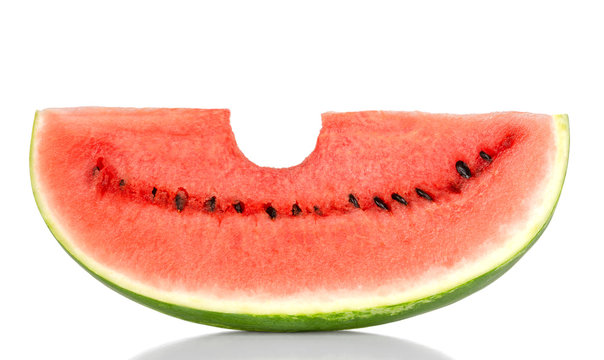 Bitten into a sweet watermelon slice, front view, over white. Large ripe fruit of Citrullus lanatus with green striped skin, red pulp and black seeds. Edible, raw and organic. Food photo, closeup.