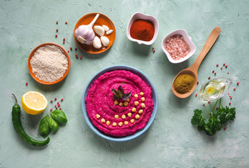 Hummus with beets on the table and ingredients for traditional hummus.