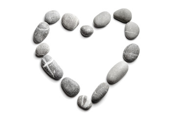 Pebbles on white background, sea pebble. Symbol in the form of heart. The concept of passion for...