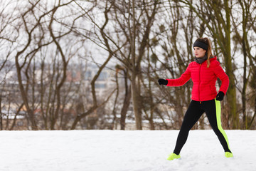 Woman wearing sportswear exercising during winter