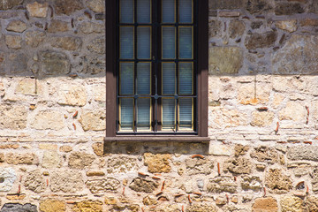 Old brick wall with brick filled window.