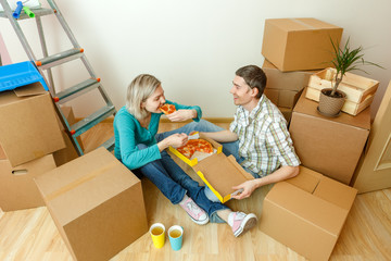 Photos of women and men eating pizza among cardboard boxes