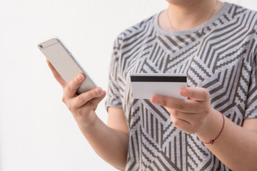 Woman hands holding credit card and using smart phone for Online payment, Online shopping, isolated on white background