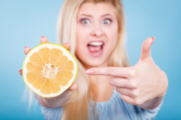 Woman pointing on grapefruit citrus fruit