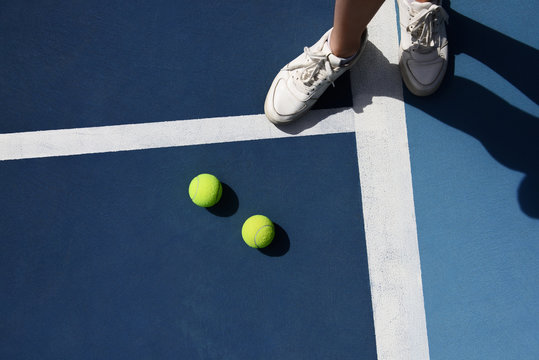 Tennis player standing at balls