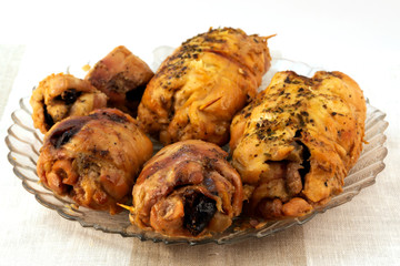 Meat rolls with prunes, baked in the oven, fixed with wooden sticks.